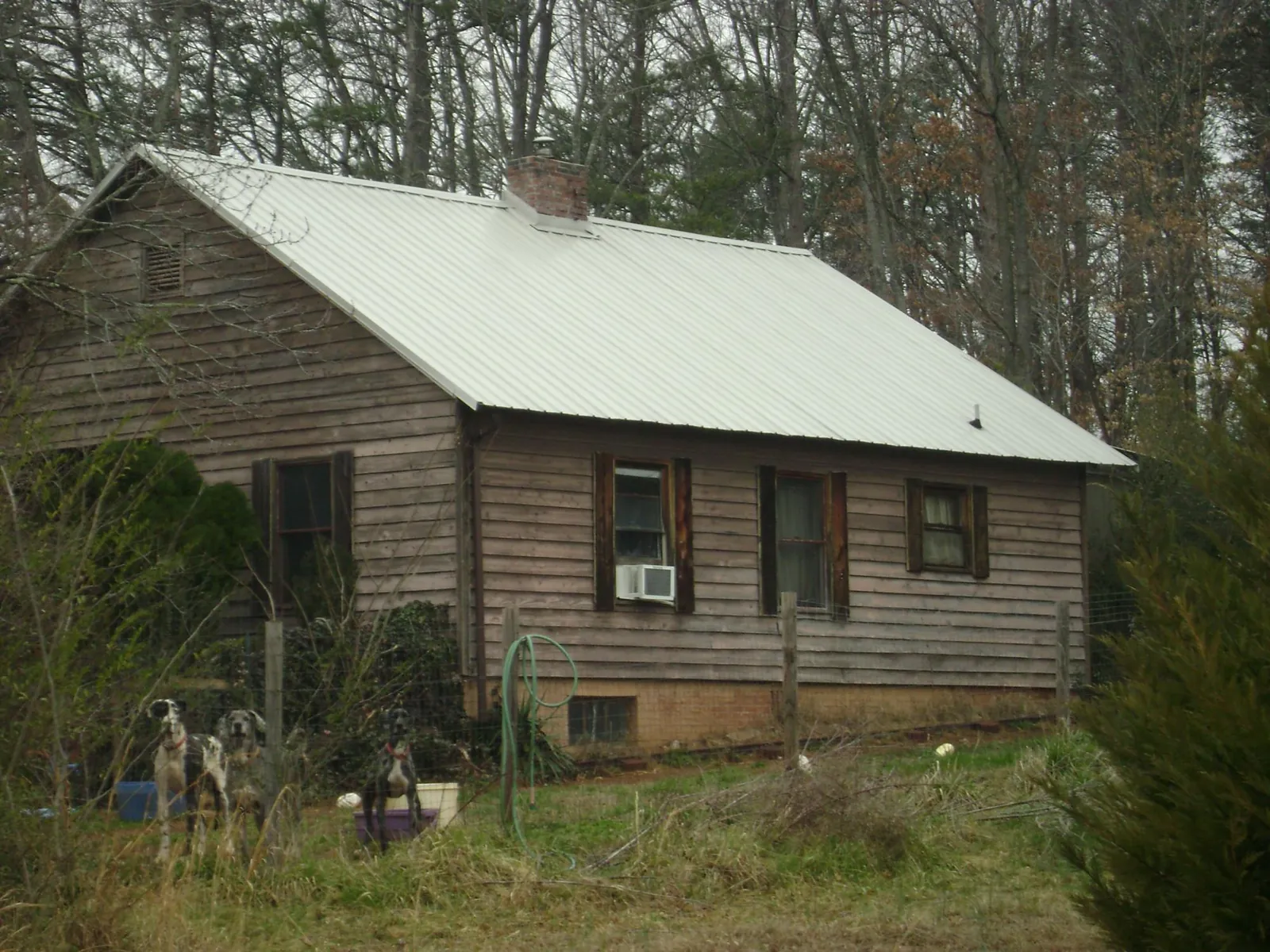 White metal roof on an old wood sided farmhouse, from a Metal Roof Installation job in Hallsboro